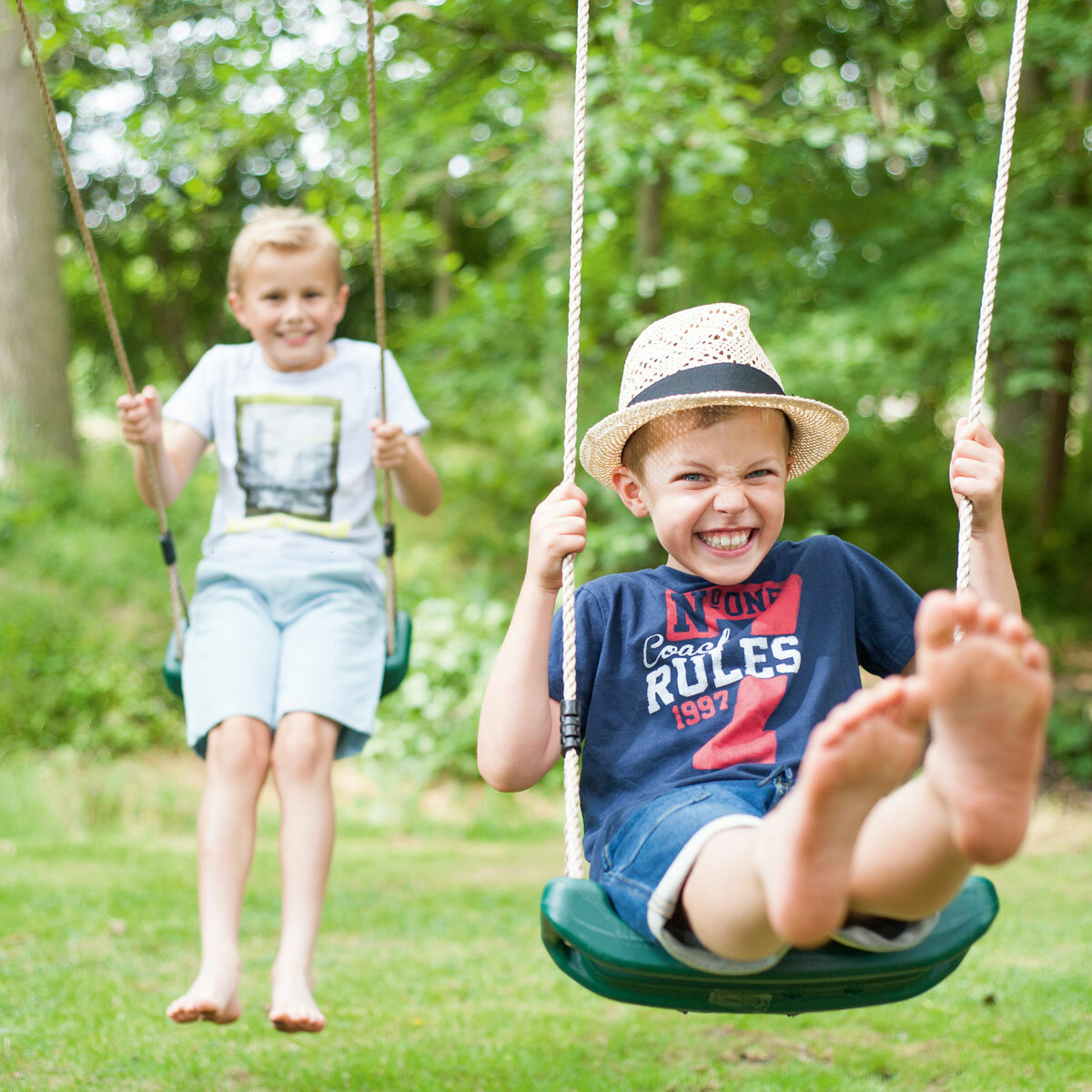 Lifestyle image of two children on the swings Lifestyle image of two children on the swings