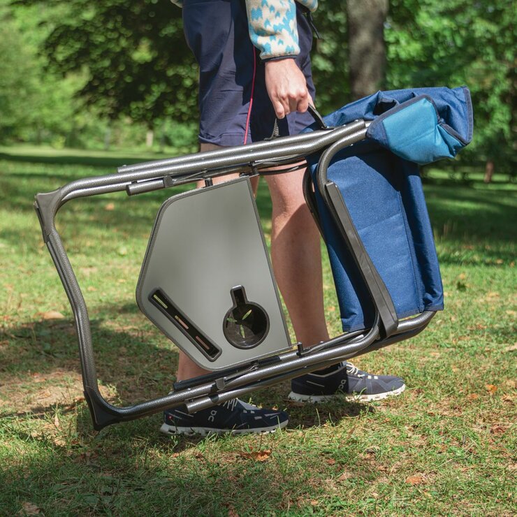 Lifestyle image of the Director's Chair, folded and being carried