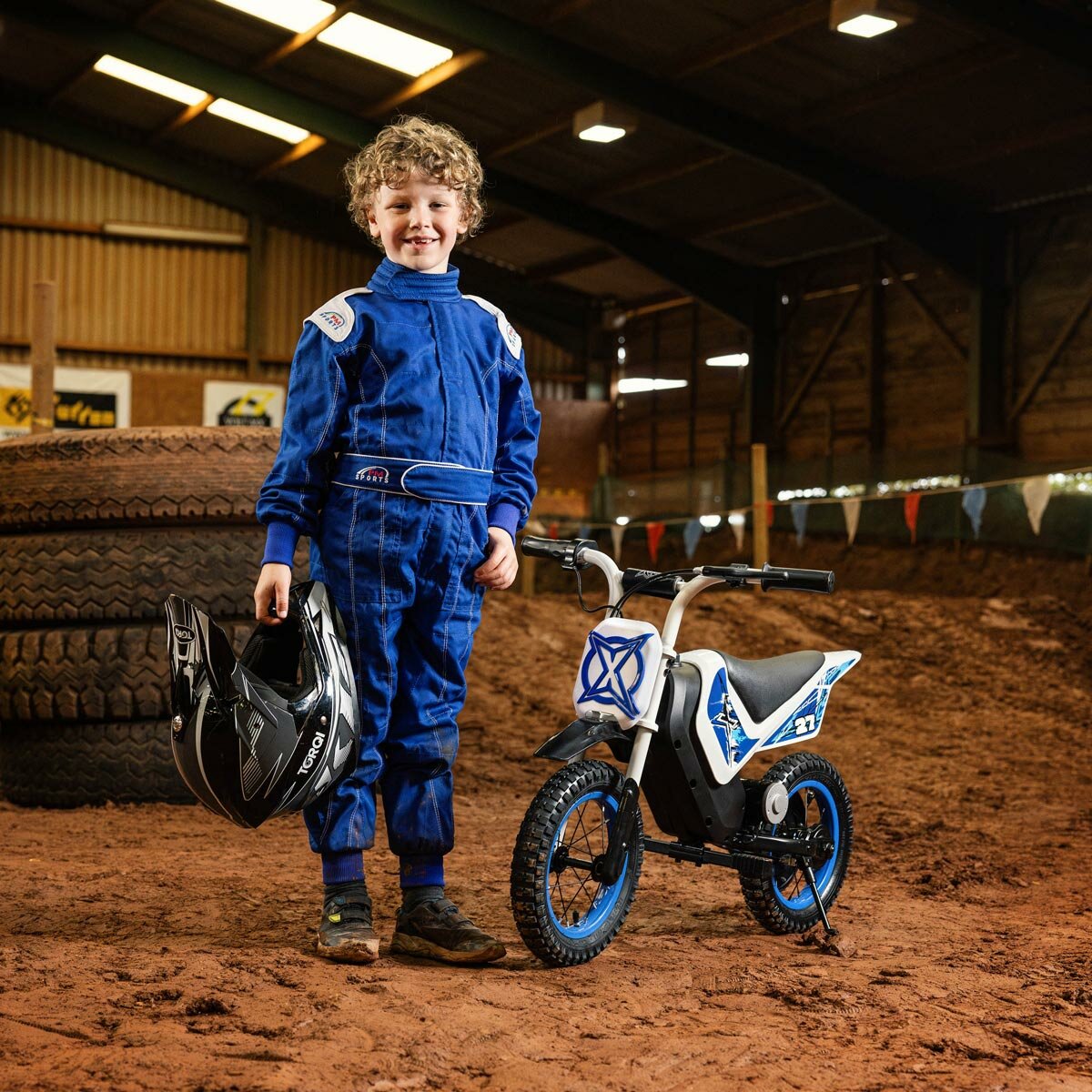 Lifestyle image fo a child next to the Xootz Cobolt Kids Electric Motorbike