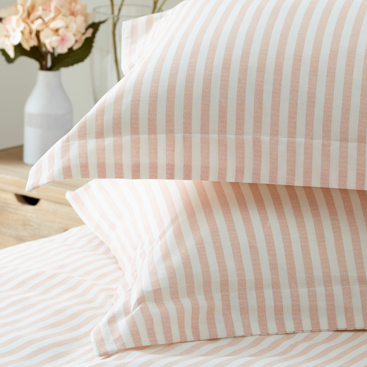 Pink and white vertically striped duvet set with matching pillowcases.