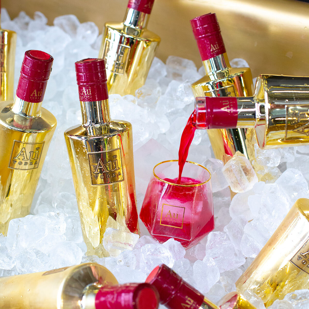 Au Cherry Vodka being poured into a glaa in an ice tray