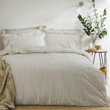 Beige and white vertically striped duvet set with matching pillowcases.