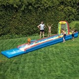 Lifestyle image of a family playing with the Wham-O Slip N' Slide Air Splash Zone (32 ft)