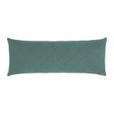 Quilted green body pillow with diamond stitching placed in front of two white pillows on a neatly Quilted green body pillow with diamond stitching placed in front of two white pillows on a neatly