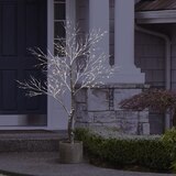 Buy 7ft Potted Brown Flocked Tree Lifestyle2 Image at Costco.co.uk