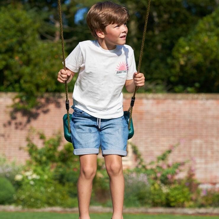 A lifestyle image of three children on a swing A lifestyle image of three children on a swing