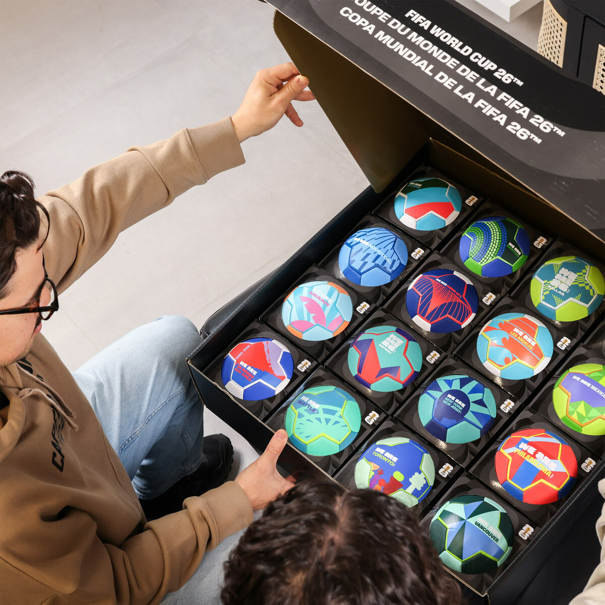 Lifestyle image showing the FIFA World Cup 2026 Host City Footballs in the box with the lid open