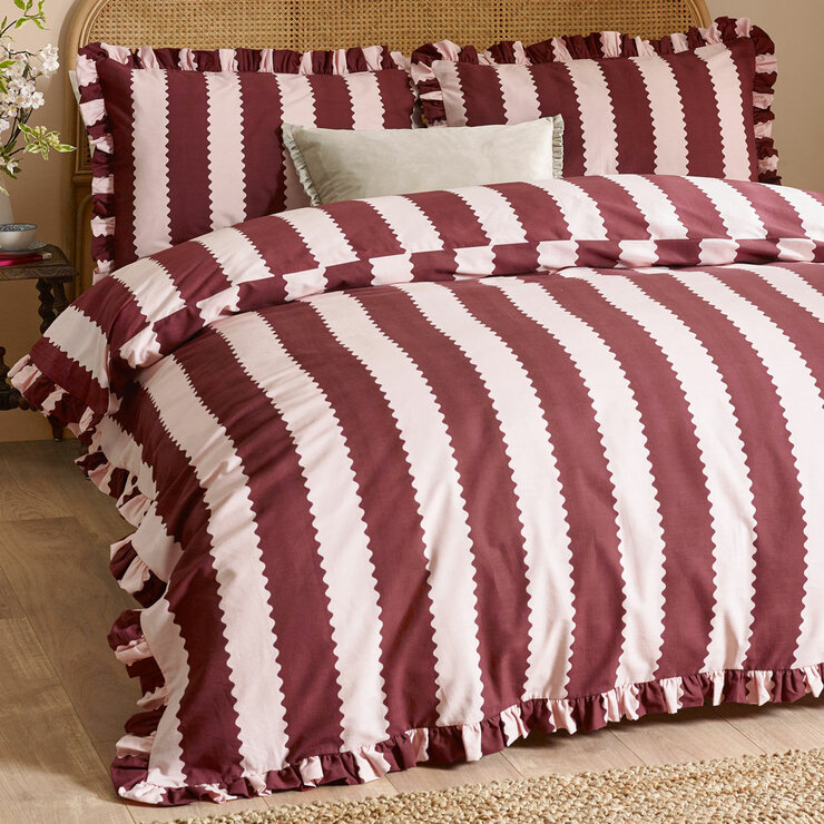 Burgundy and white vertically striped duvet set with ruffled edges and matching pillowcases Burgundy and white vertically striped duvet set with ruffled edges and matching pillowcases