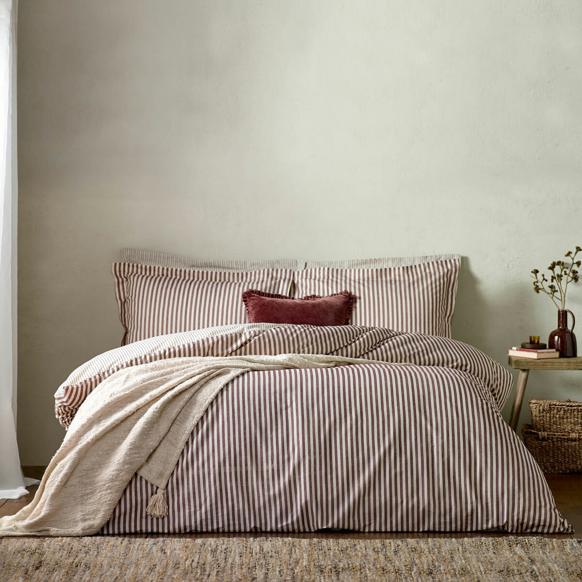 Striped duvet set with vertical burgundy and white lines, paired with matching pillowcases
