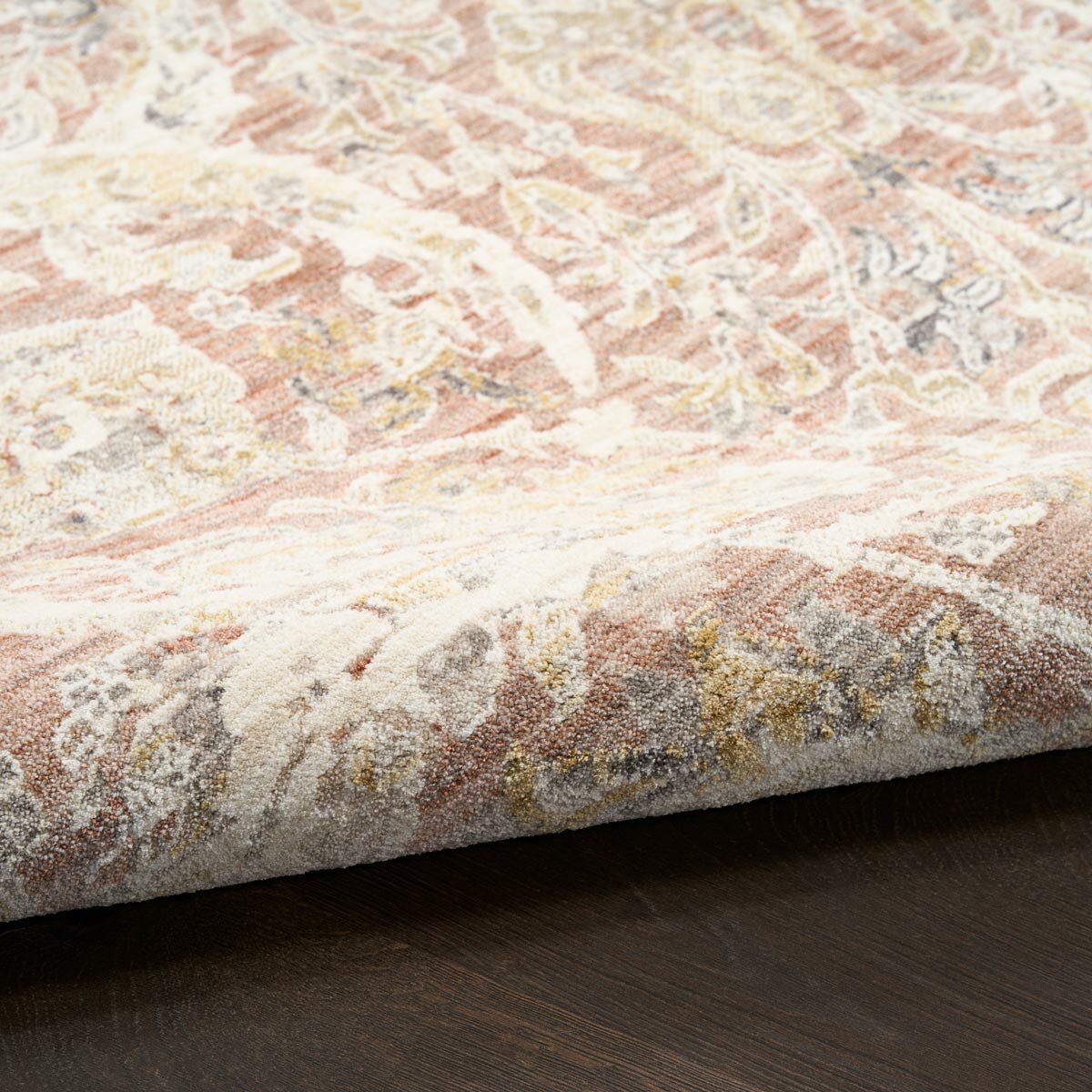 Pink and beige patterned rug with vintage-style floral and geometric motifs Pink and beige patterned rug with vintage-style floral and geometric motifs