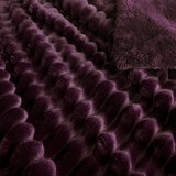 Zoomed in imagery of purple ribbed throw, texured and soft Zoomed in imagery of purple ribbed throw, texured and soft