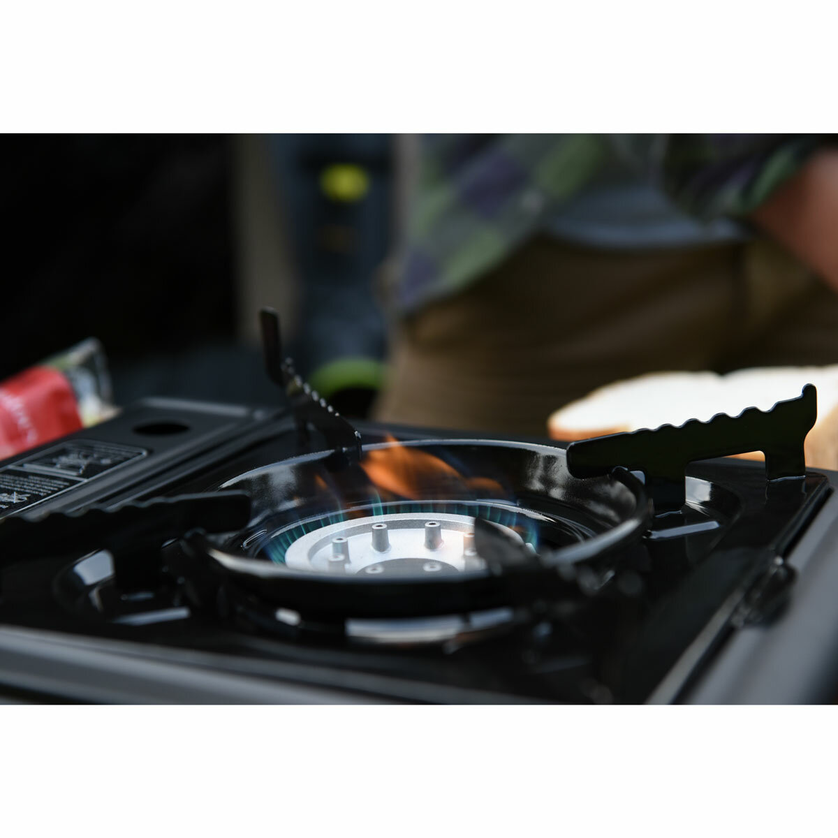 Lifestyle image of the stove with a lit flame