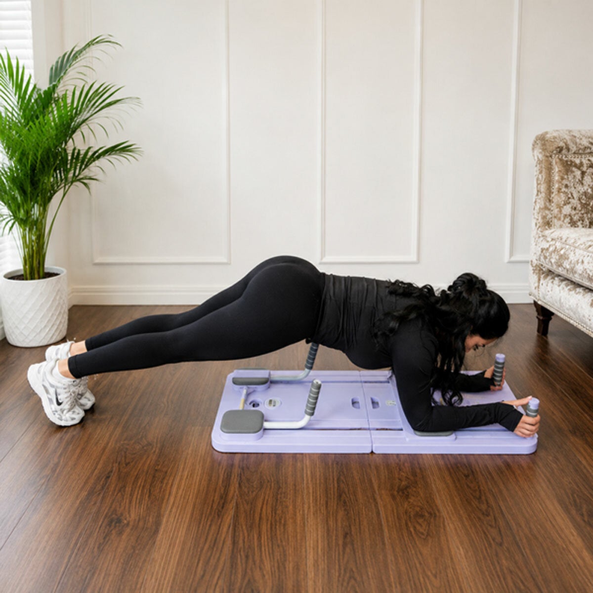 Lifestyle image of a woman using the Pilates Reformer