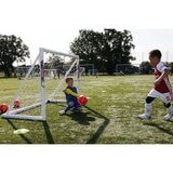 Lifestyle image of two children playing football using the goal
