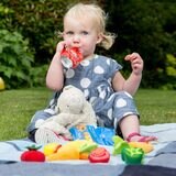 Little Girl Eating A Pouch