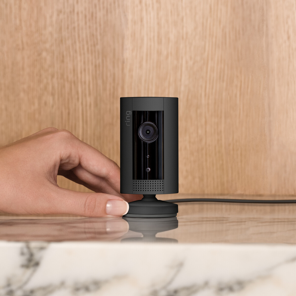Lifestyle image of indoor cam on marble shelf