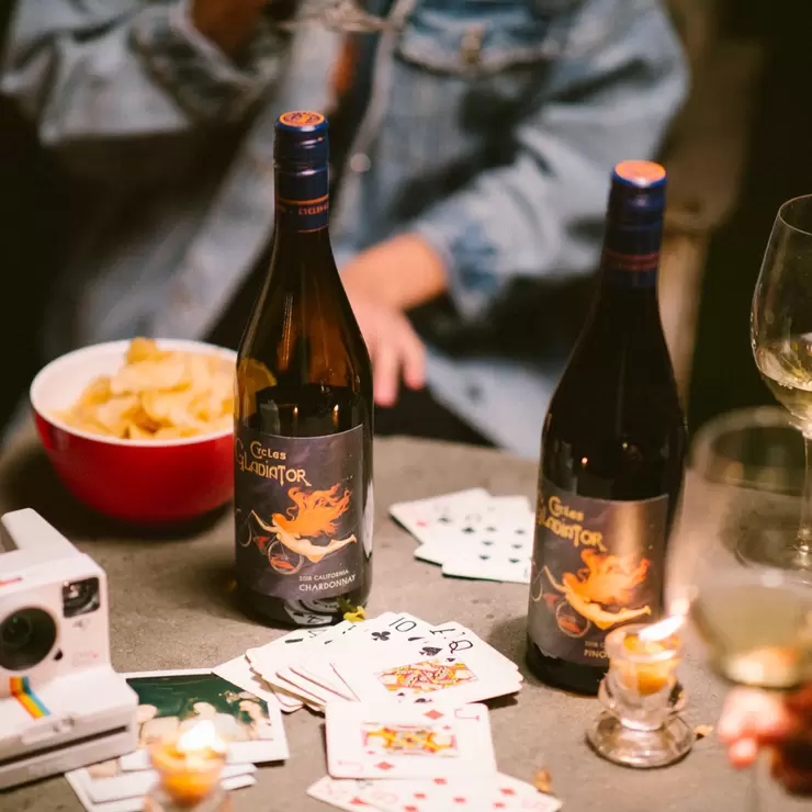 Image of bottle of wine with camera, cards and crisps Image of bottle of wine with camera, cards and crisps