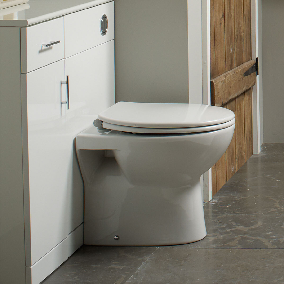 Lifestyle image of toilet seat on bowl unit in bathroom setting