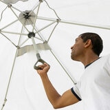 Lifestyle image of a man pushing the centre of the screenhouse up Lifestyle image of a man pushing the centre of the screenhouse up