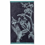 Dark blue towel with a light blue bird and branch illustration, teal borders, and “TED BAKER” branding