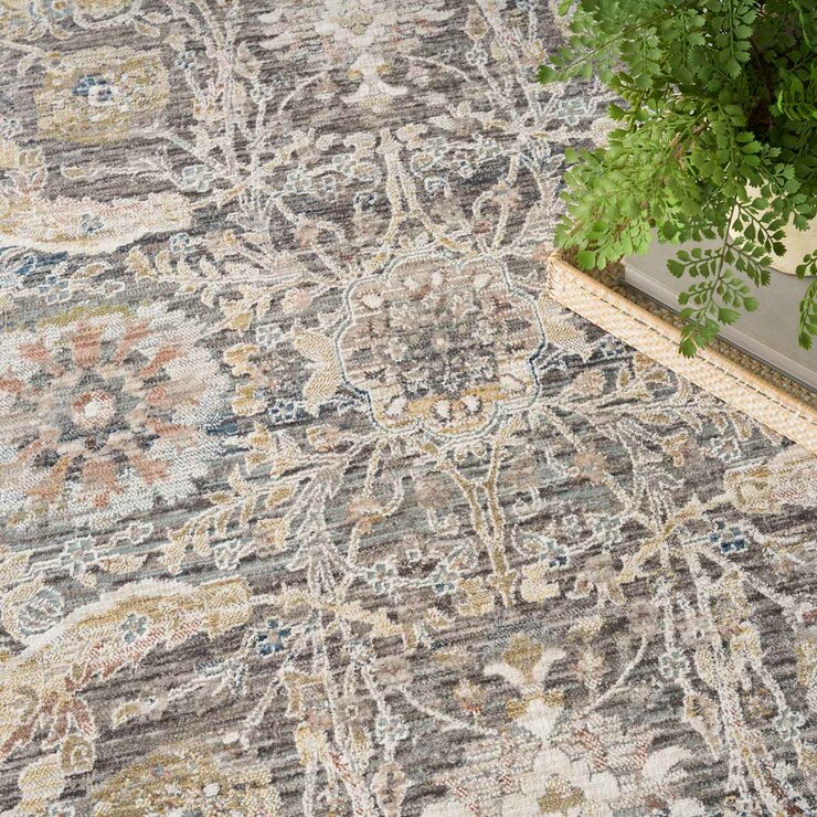 Grey and beige rug with detailed symmetrical pattern and vintage-style accents