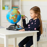 A girl  playing with the Leapfrog interactive globe