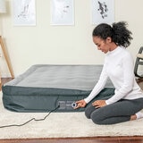 Lifestyle image of a woman deflating the airbed Lifestyle image of a woman deflating the airbed