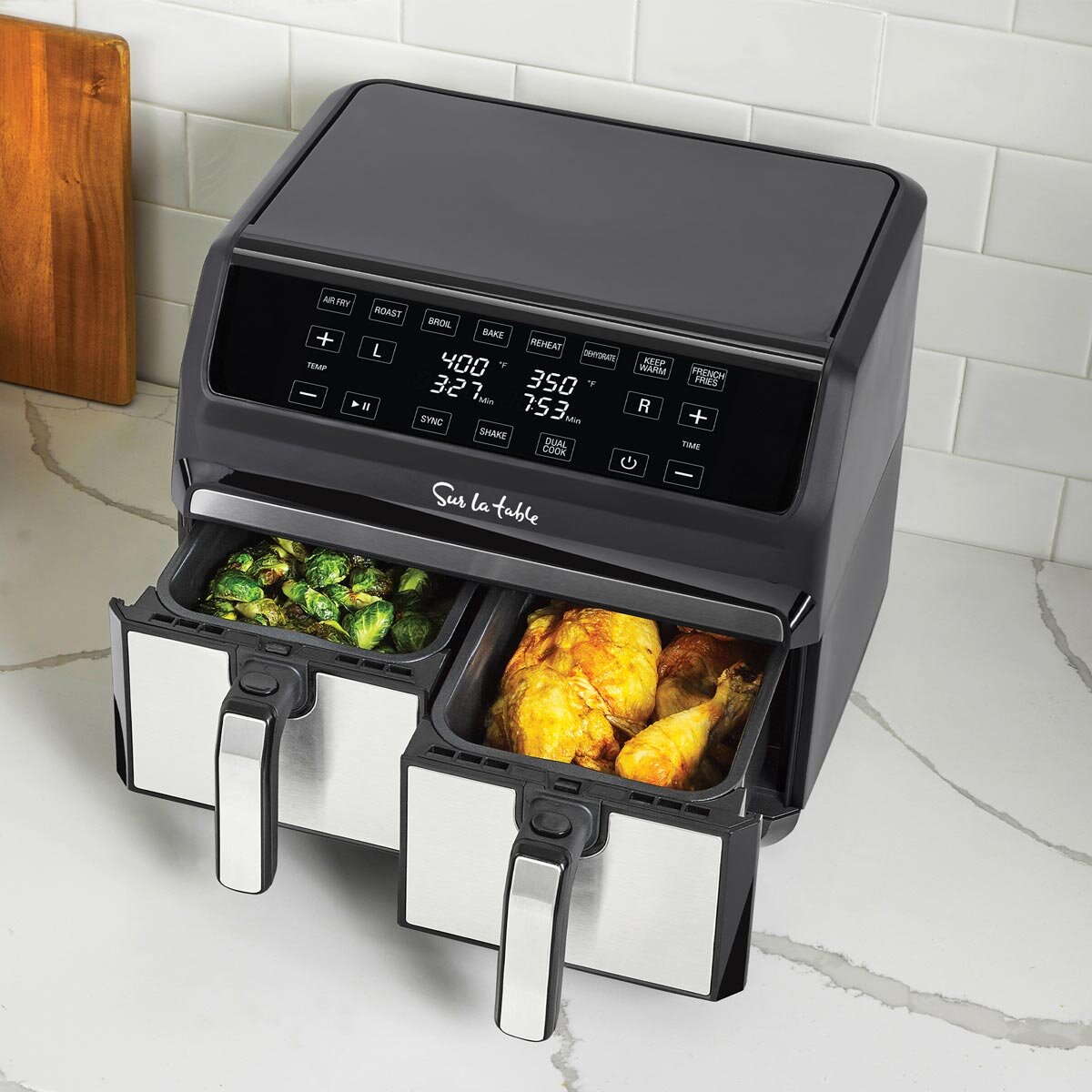 Lifestyle image of sur la table dual basket air fryer with drawers open