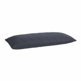 Quilted blue body pillow with diamond stitching placed in front of two white pillows on a neatly