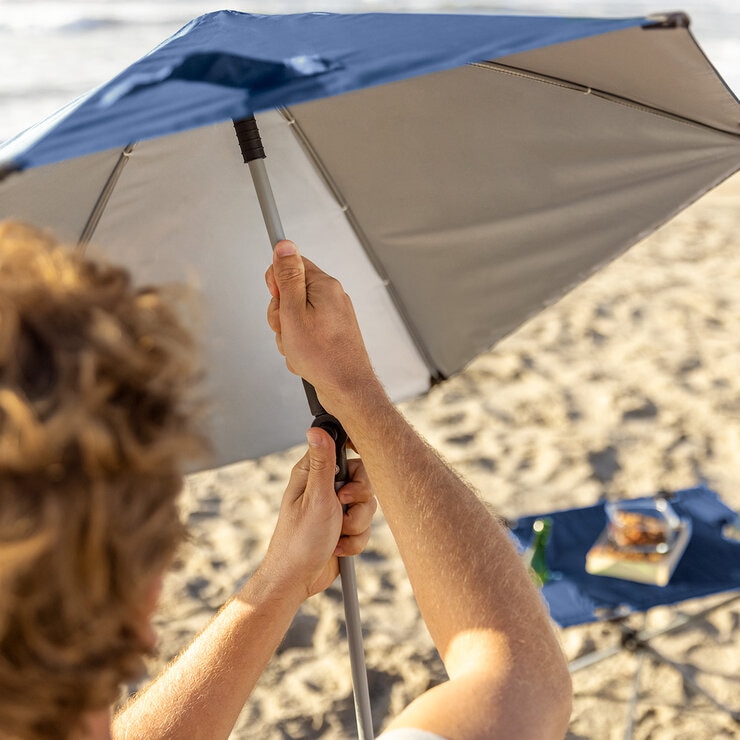 Lifestyle image of someone adjusting the umbrella