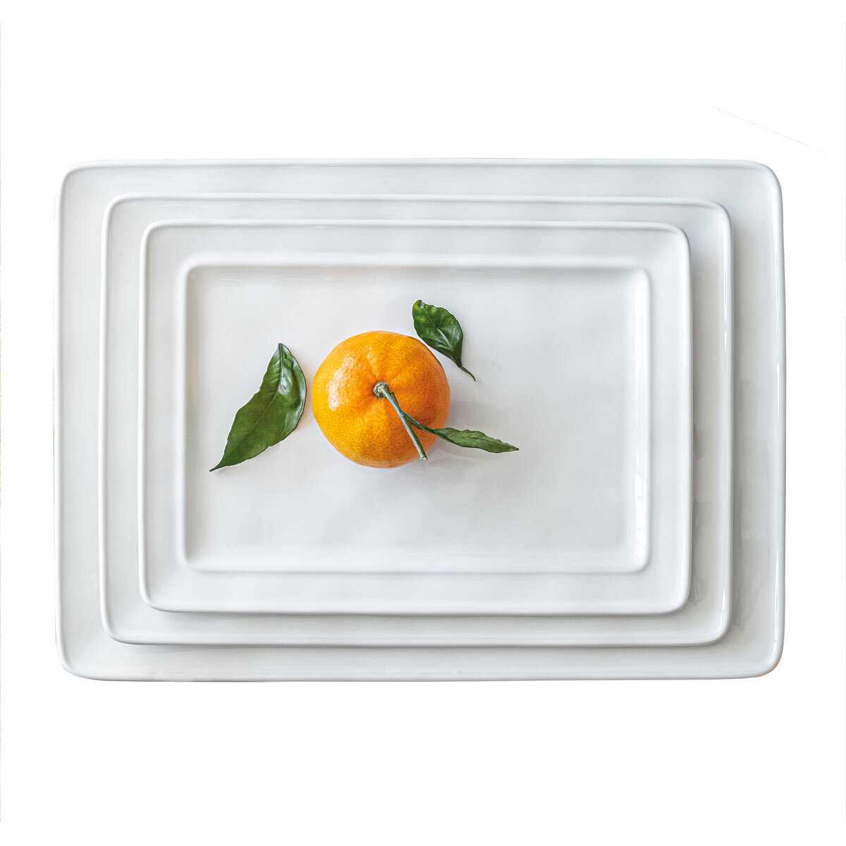 Stacked serving platters with orange