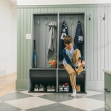 Lifestyle image showing a child putting his shoes on while sat on the locker Lifestyle image showing a child putting his shoes on while sat on the locker