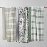 Plaid and floral throws in colours: Sage green, Taupe and black + white staged on a rail Plaid and floral throws in colours: Sage green, Taupe and black + white staged on a rail