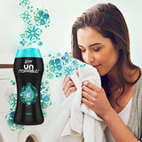 image of bottle and lady smelling towel