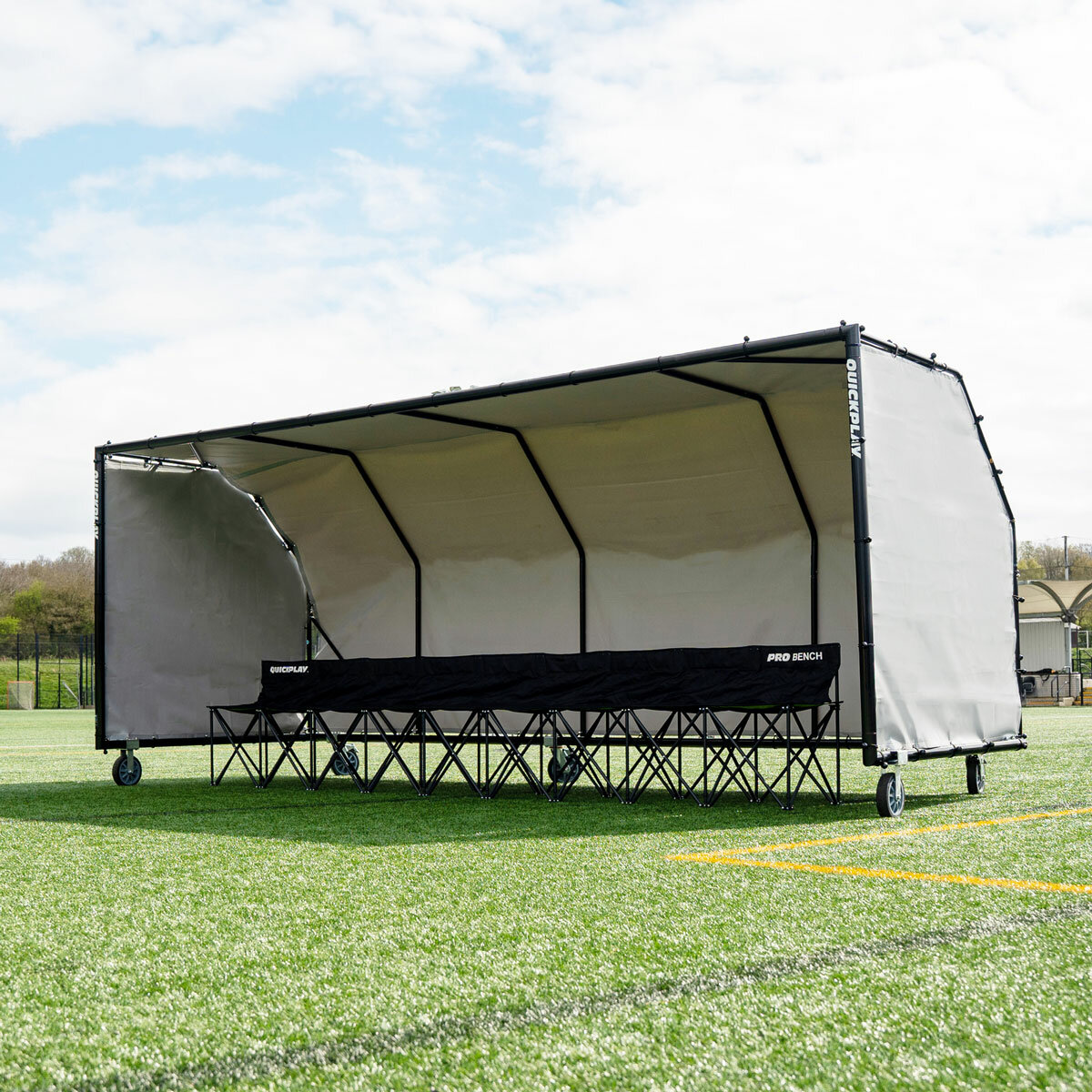 Lifestyle image of the Quickplay Pro Alu Club Shelter 16 x 6ft with chairs underneath (not included)