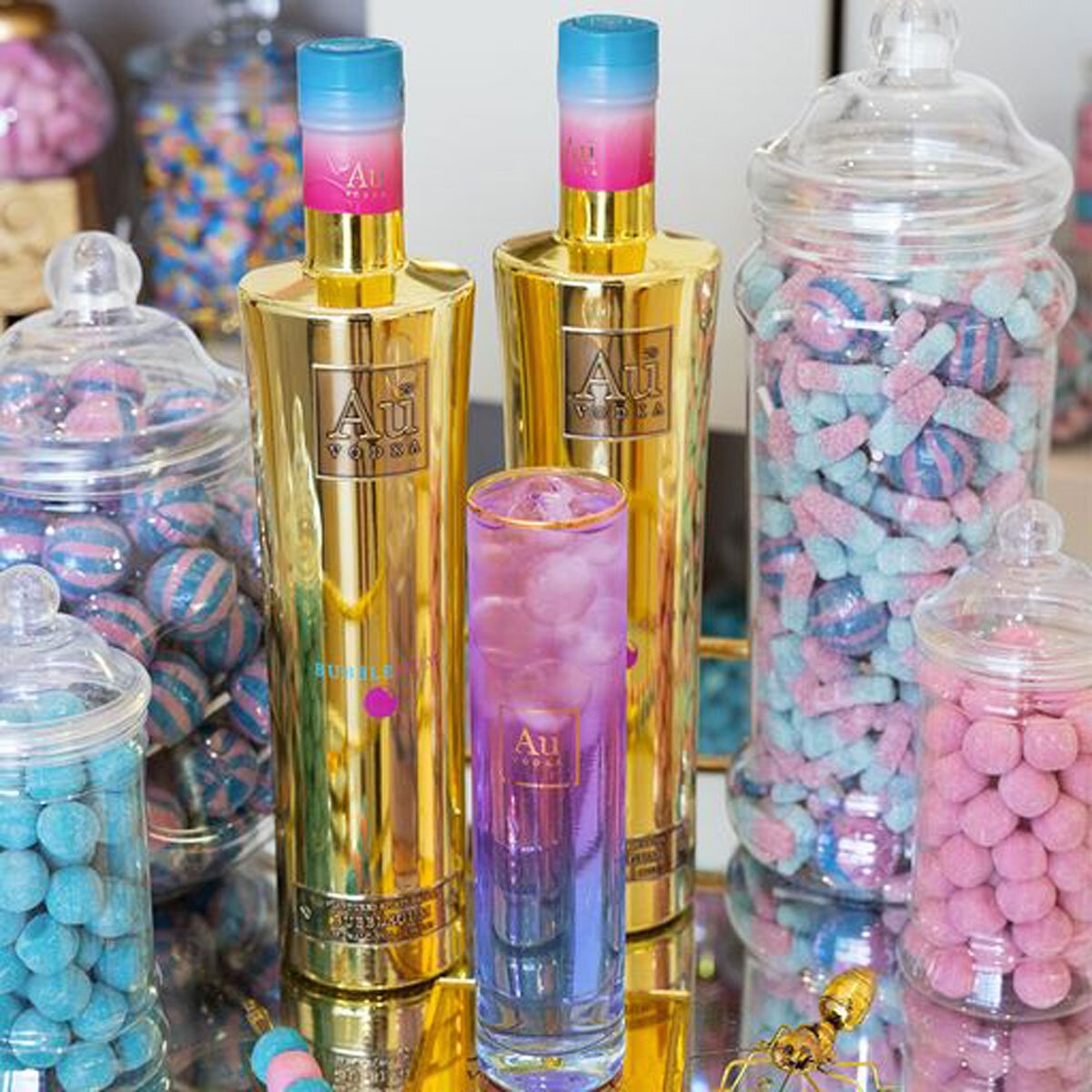 Tall glass surrounded by sweets
