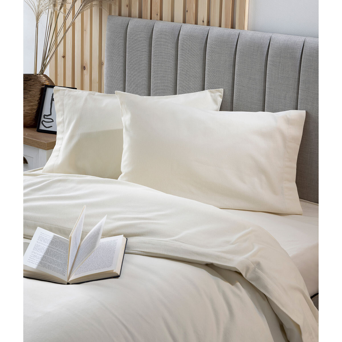image showing cream snug bundle set up close featuring the pillow cases and top of mattress