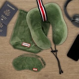 Green travel pillow with striped detail and matching green eye mask