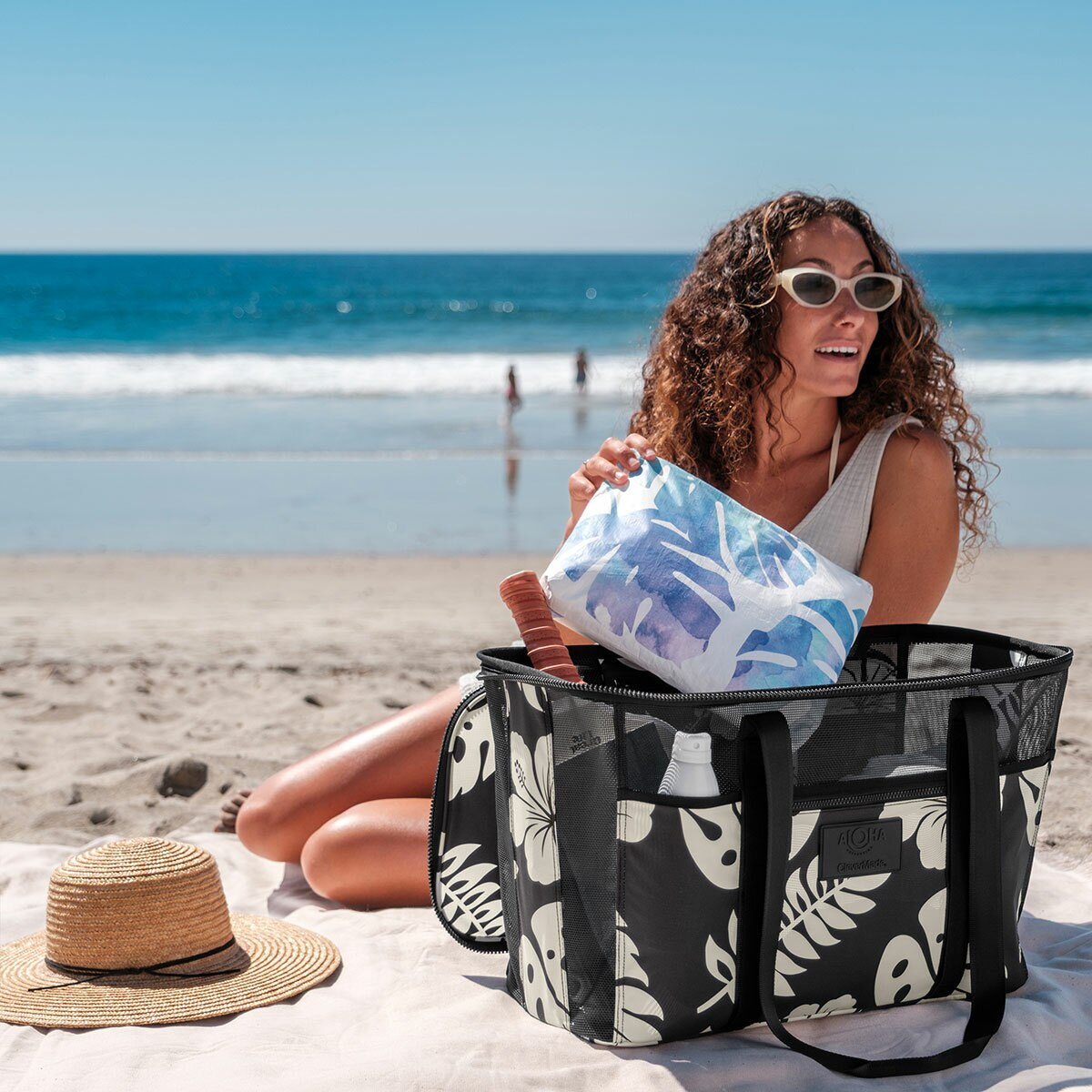 Lifestyle image of a woman putting items into the bag Lifestyle image of a woman putting items into the bag