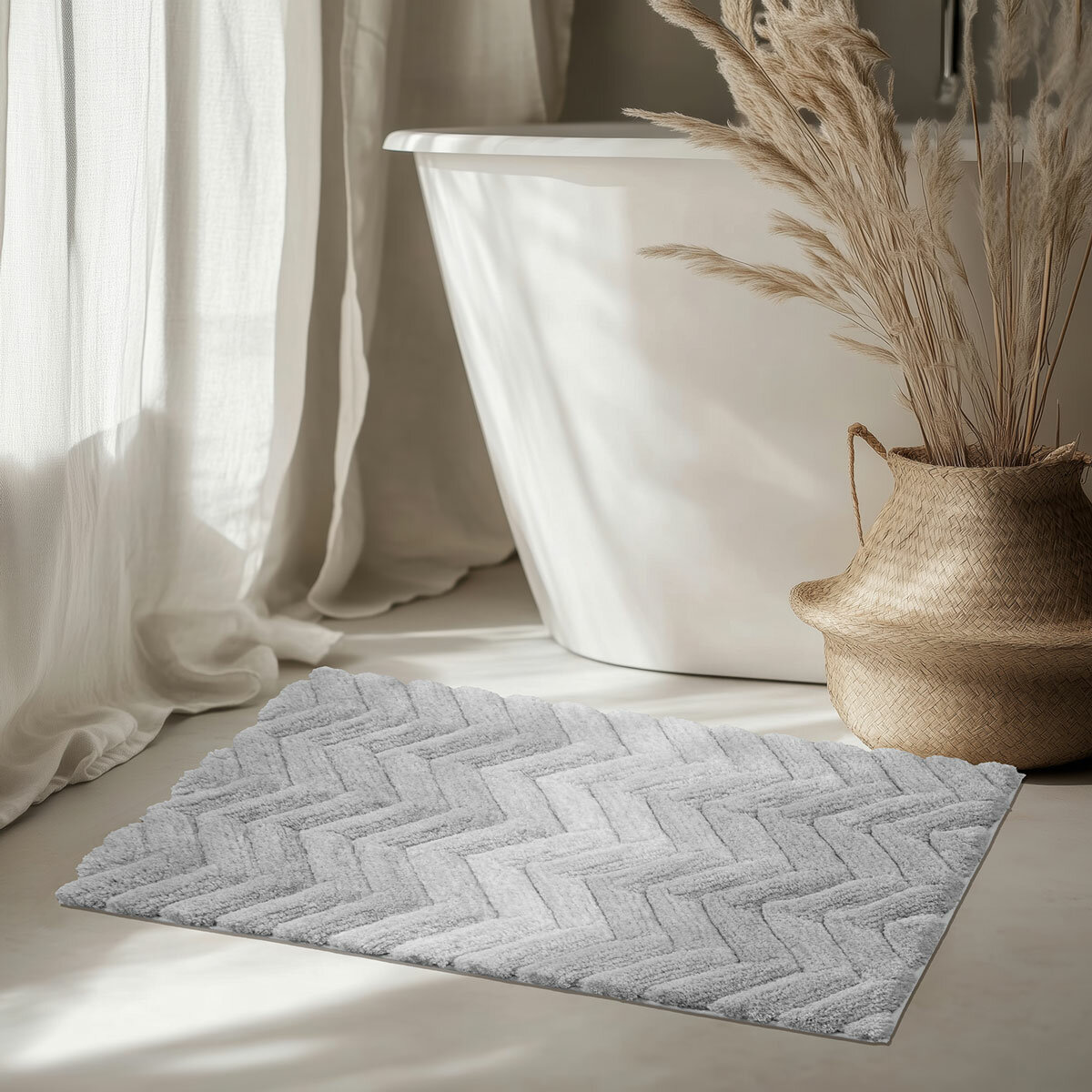 Textured bath mat placed in front of white bathtu
