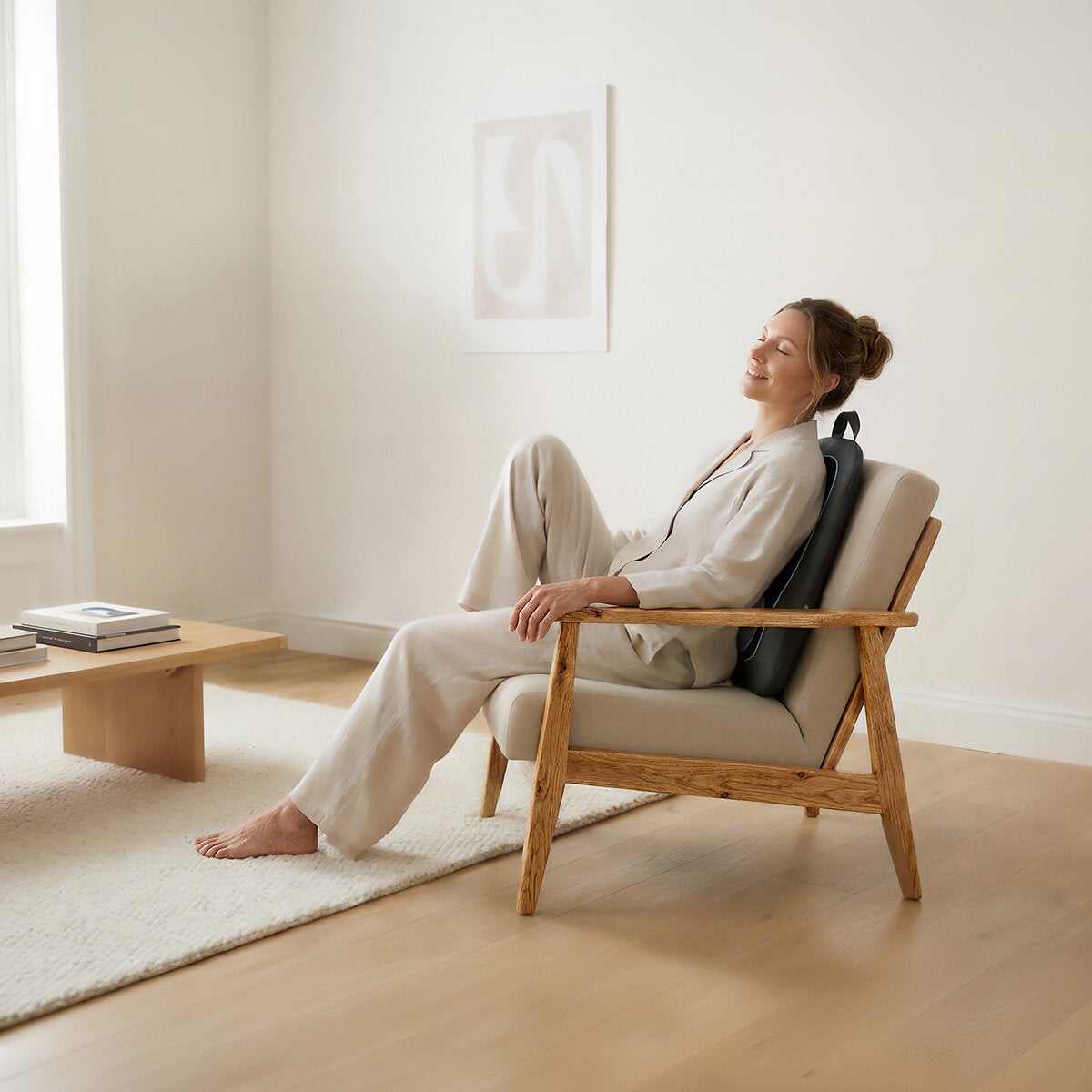 Lifestyle image of model using the back massager Lifestyle image of model using the back massager