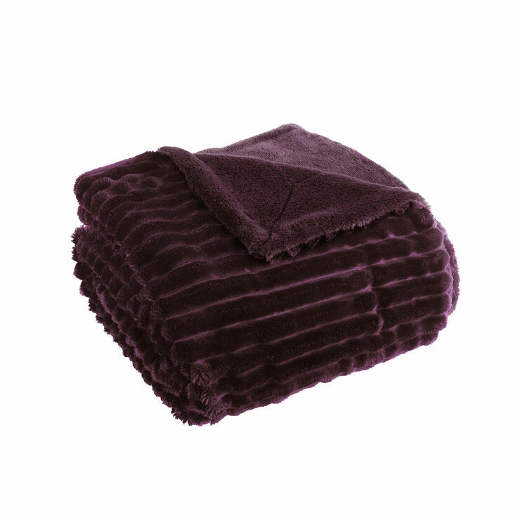 Plain background imagery of purple ribbed throw folded