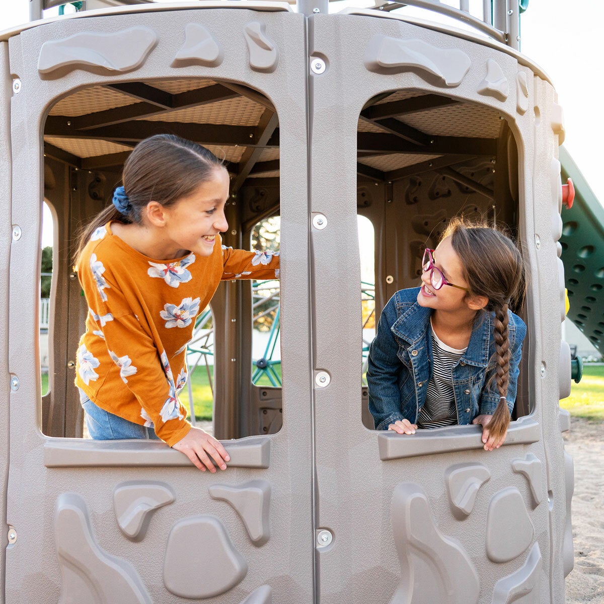 Lifestyle image of two children looking at each other through the windows on the playset Lifestyle image of two children looking at each other through the windows on the playset