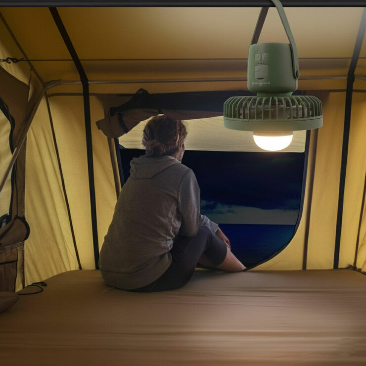 Lifestyle image showing the camping fan hanging from the top of a tent