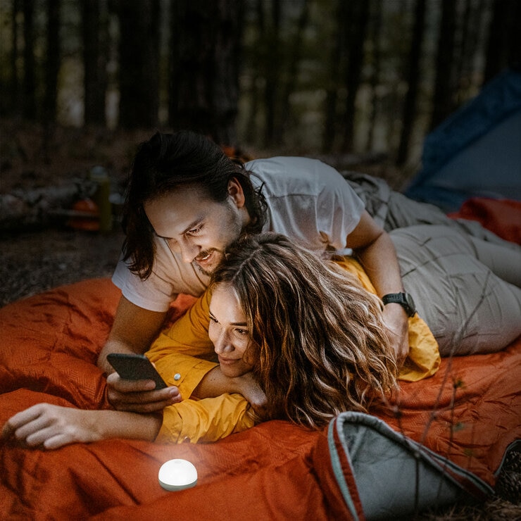 Lifestyle image showing a couple laying down next to the LED light