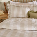 Beige and white striped duvet set with ruffled edges and matching pillow shams.