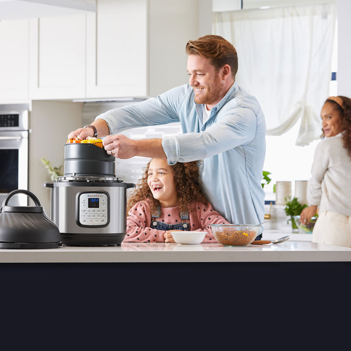 Lifestyle image of Instant Pot Duo Crisp 8 with family cooking