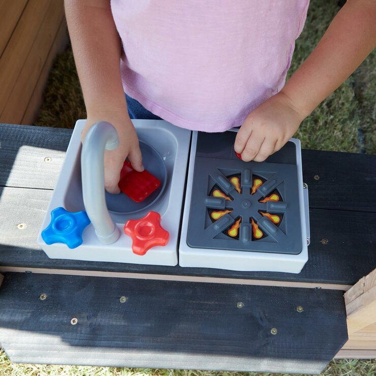 Lifestyle image of a child playing in the kitchen area