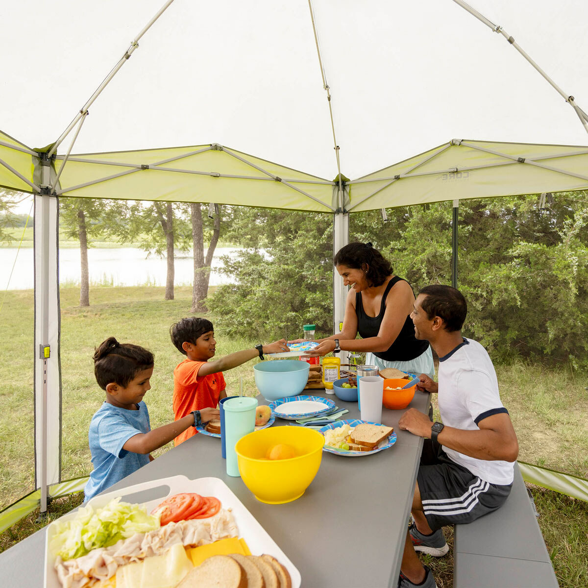 Lifestyle image of people sitting at a table inside the screenhouse Lifestyle image of people sitting at a table inside the screenhouse