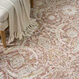 Pink and beige patterned rug with vintage-style floral and geometric motifs Pink and beige patterned rug with vintage-style floral and geometric motifs